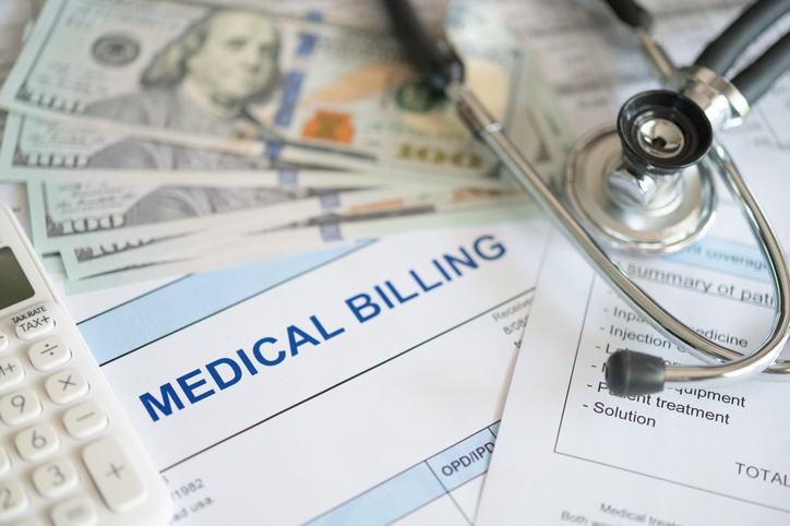 Pile of medical pills with $20 bills, stethoscope, and calculator